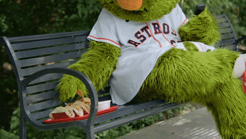 A Mascot For The Astros Sits On A Bench GIF