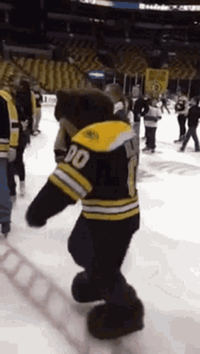 A Mascot For The Boston Bruins Is Dancing On The Ice GIF