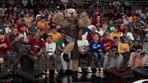 A Mascot For The Cleveland Cavaliers Stands In Front Of A Crowd Of Spectators GIF