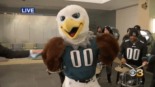 A Mascot For The Eagles Is Playing Drums GIF