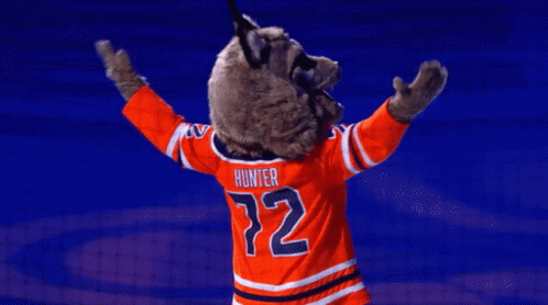 A Mascot For The Edmonton Oilers Is Standing On A Blue Background GIF