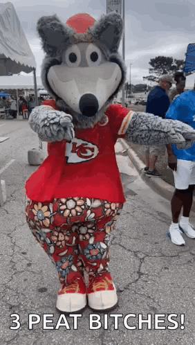 A Mascot For The Kansas City Chiefs Is Standing On A Sidewalk . GIF