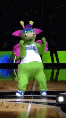 A Mascot For The Magic Basketball Team Is Dancing On A Court GIF