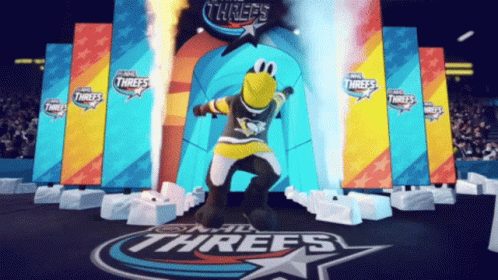 A Mascot For The Nhl Threes Is Dancing In Front Of A Stage GIF