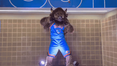 A Mascot For The Oklahoma City Thunder Stands In A Bathroom GIF