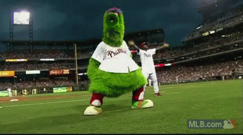 A Mascot For The Phillies Is Dancing On A Baseball Field GIF