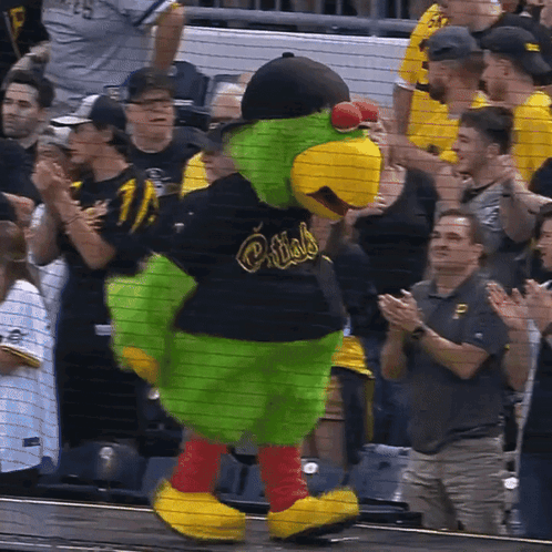 A Mascot For The Pittsburgh Pirates Is Standing In Front Of A Crowd GIF