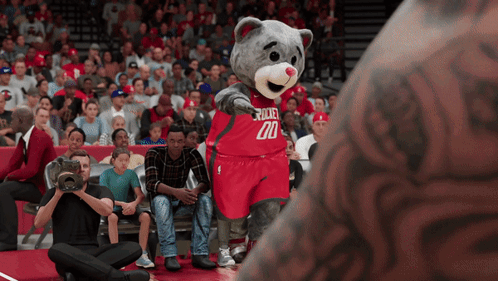 A Mascot For The Rockets Wears A Red Jersey With The Number 20 On It GIF