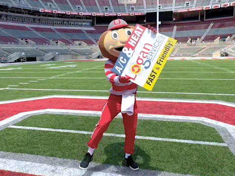 A Mascot Holding A Sign That Says " Logan Services " GIF