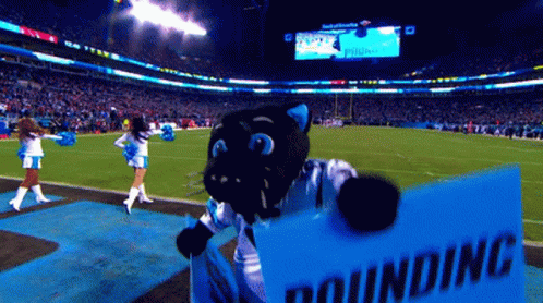 A Mascot Holding A Sign That Says Pounding On It GIF