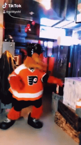 A Mascot In A Flyers Jersey Is Dancing In A Room GIF
