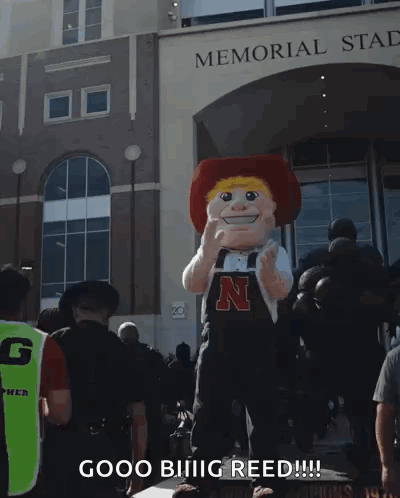 a mascot in front of the memorial stadium says good biiiig reed