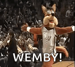 A Mascot Is Dancing In Front Of A Crowd At A Basketball Game And Says Wemby . GIF