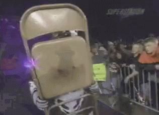 A Mascot Is Holding A Chair In Front Of His Face GIF