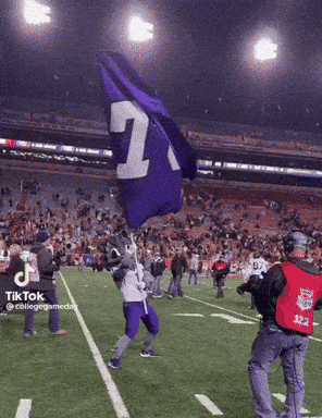 a mascot is holding a flag with the number 1 on it