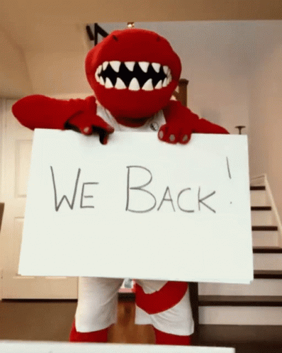 A Mascot Is Holding Up A Sign That Says We Back GIF