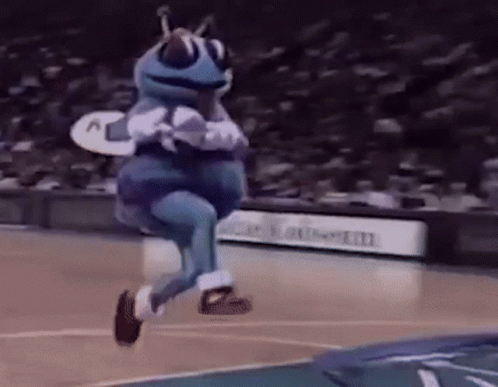 A Mascot Is Jumping In The Air On A Basketball Court . GIF