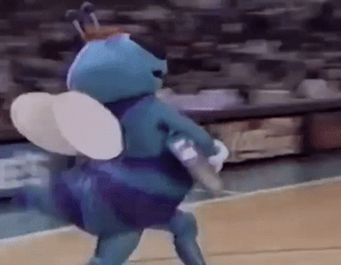 A Mascot Is Playing Basketball On A Court . GIF