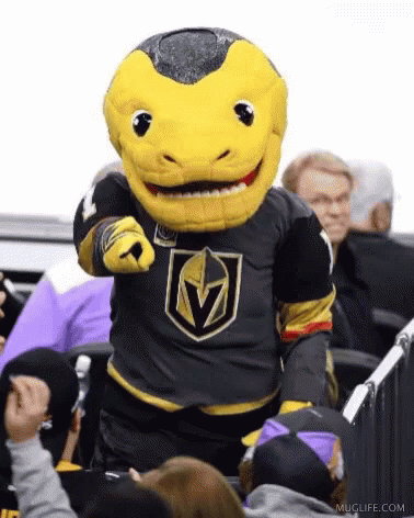 A Mascot Is Pointing At The Camera While Standing In Front Of A Crowd . GIF