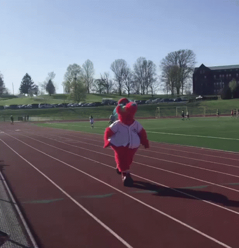 A Mascot Is Running On A Track Wearing A White Jersey GIF