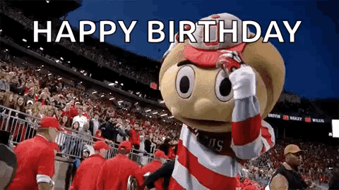 A Mascot Is Standing In Front Of A Crowd In A Stadium And Says Happy Birthday . GIF