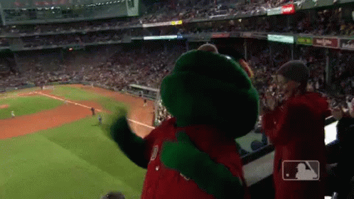 A Mascot Is Standing In The Stands At A Baseball Game And Giving A Thumbs Up . GIF