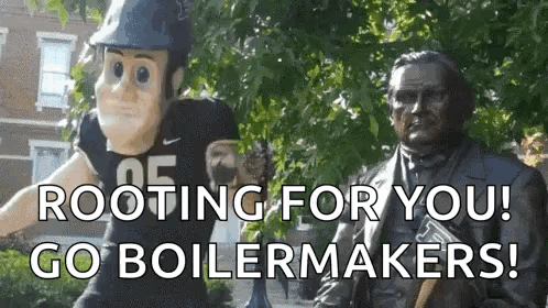 a mascot is standing next to a statue of abraham lincoln .
