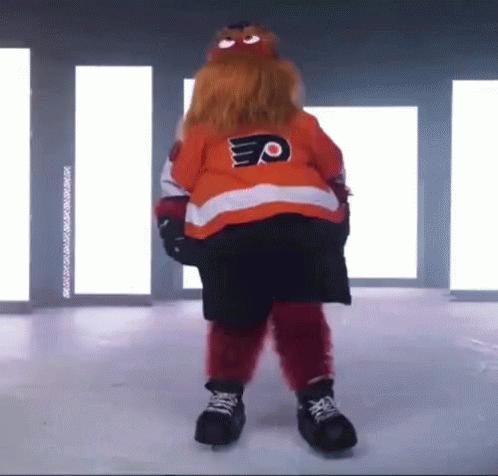 A Mascot Is Standing On A Ice Rink Wearing A Jersey With The Letter P On It . GIF