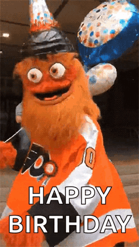 A Mascot Is Wearing A Birthday Hat And Holding Balloons And Says Happy Birthday . GIF