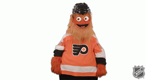A Mascot Is Wearing A Flyers Jersey And The Nhl Logo Is Behind Him GIF