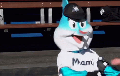 A Mascot Is Wearing A Miami Shirt And A Black Hat GIF