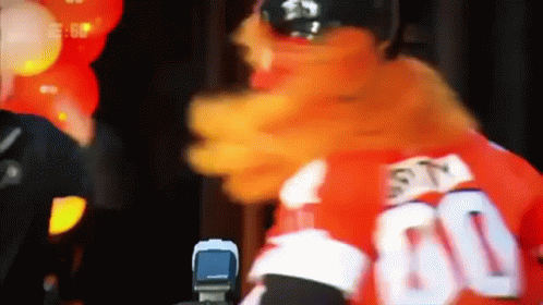 A Mascot Is Wearing A Red Jersey With The Number 60 On It GIF