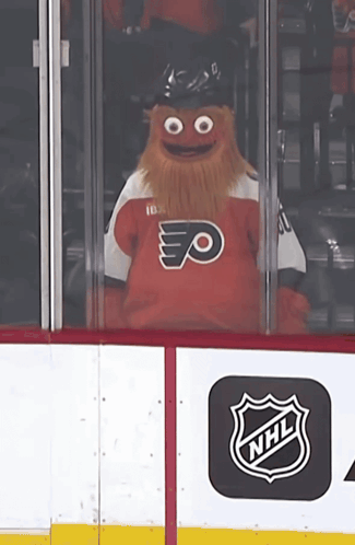 A Mascot Wearing A Flyers Jersey Looks Out Of A Window GIF