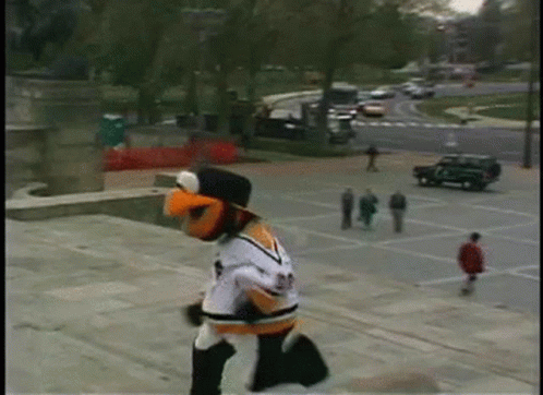 A Mascot Wearing A Jersey With The Number 23 On It Is Running Down A Set Of Stairs GIF