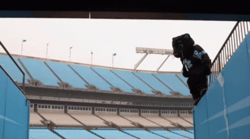 A Mascot Wearing A Number 18 Jersey Climbs A Staircase GIF