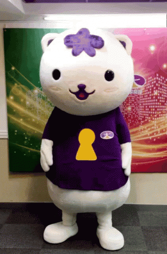 A Mascot Wearing A Purple Shirt With A Yellow Keyhole On The Chest GIF