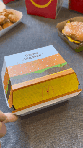 A Mcdonald 'S Box That Says Grand Big Mac On The Front GIF