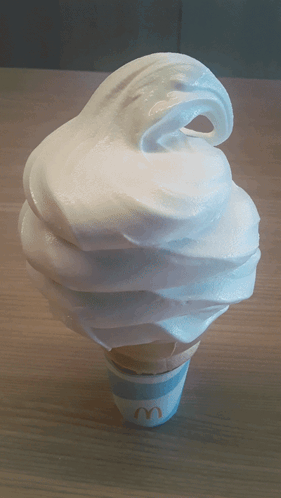 A Mcdonald 'S Ice Cream Cone With Whipped Cream GIF
