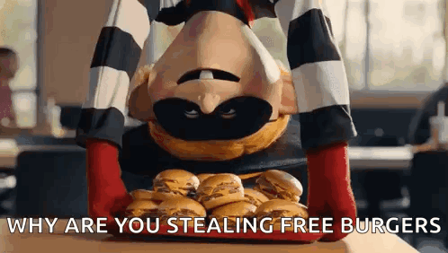 A Mcdonald 'S Mascot Is Holding A Tray Of Hamburgers . GIF