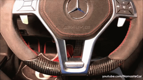 A Mercedes Amg Steering Wheel With A Carbon Fiber Steering Wheel Cover GIF