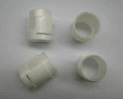 A Metal Mould With A Lot Of Holes In It Is Sitting On A White Surface . GIF