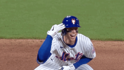 A Mets Baseball Player Wearing A Blue Helmet And White Jersey GIF
