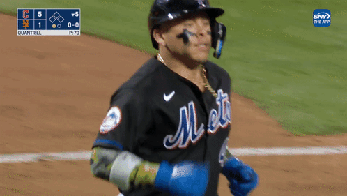 A Mets Baseball Player Wearing A Helmet And A Chain Around His Neck GIF