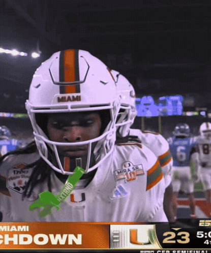 A Miami Football Player Holds A Green Gatorade Stick GIF
