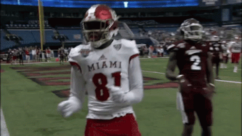 a miami football player wearing number 81 is dancing on the field