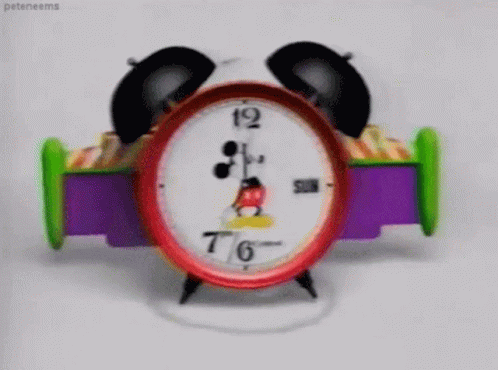 A Mickey Mouse Alarm Clock Shows That It Is 7:46 GIF