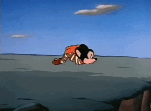 A Mickey Mouse Cartoon Character Is Laying On The Ground GIF