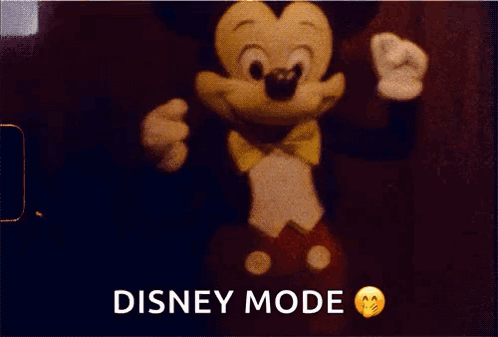 A Mickey Mouse Doll Is In Disney Mode On A Red Background GIF