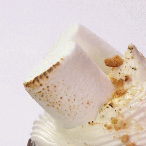 A Milkshake With Chocolate And Whipped Cream On Top Of It GIF