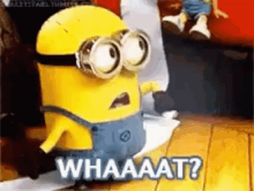 A Minion From Despicable Me Is Standing On A Wooden Floor And Says Whaaat . GIF